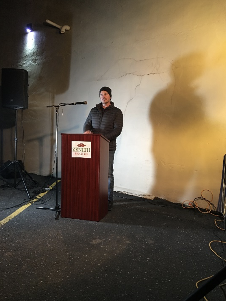 Ryan Vine at the podium in parking lot at Zenith bookstore in Duluth Oct 2021