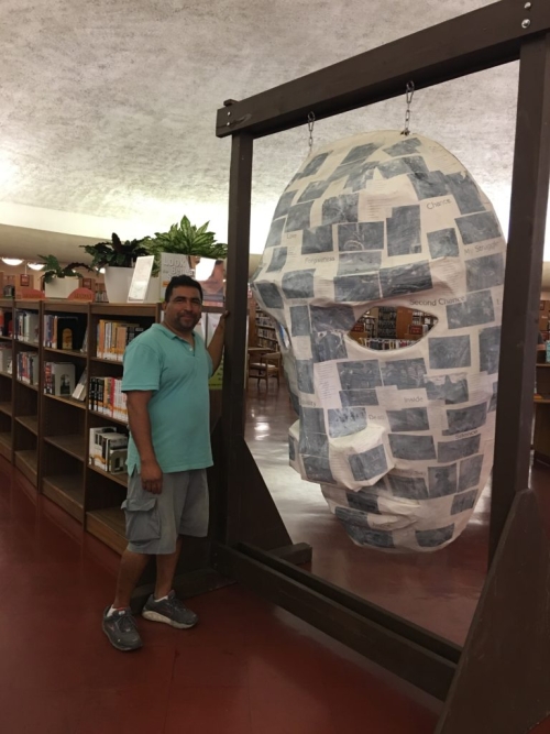 Jose Zamora with Poetry Mask created by Alejandro Lopez and ForWords Literacy Lab students at Civic Center